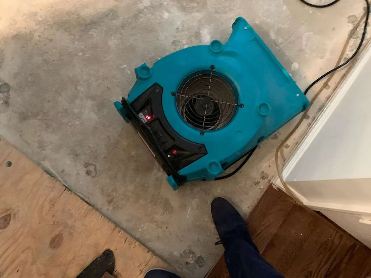 Air mover drying subfloor during Commercial Water Damage Restoration in Rockland